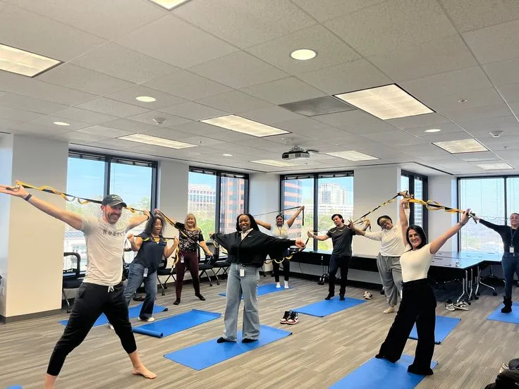 Group stretch session during a midday office break